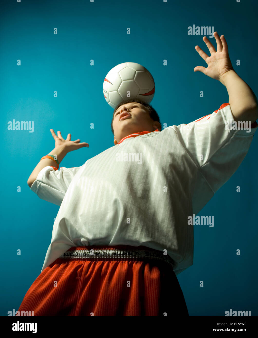 Boy balancing Soccer Ball on head Stock Photo Alamy