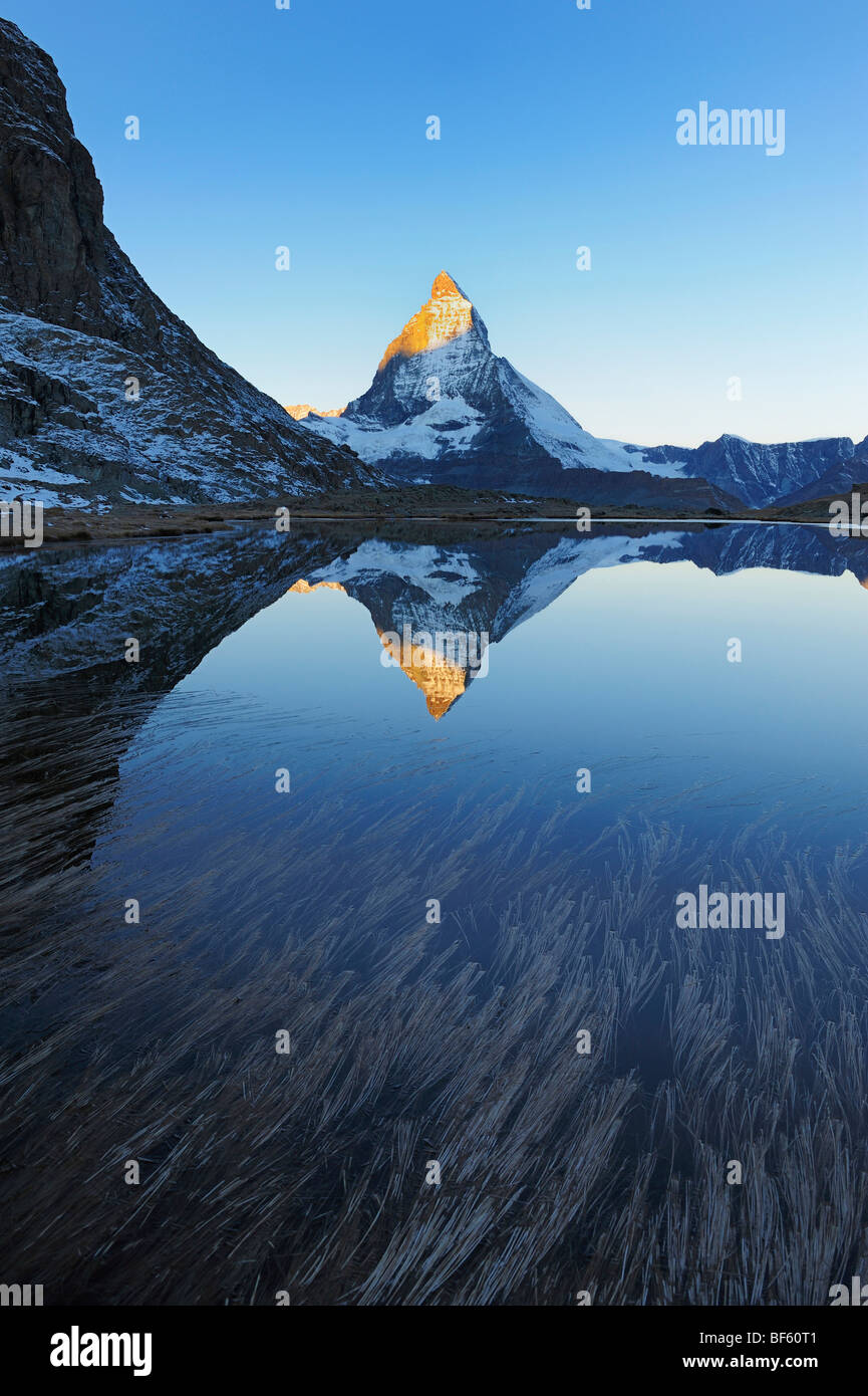 Matterhorn at sunrise in winter with reflection in the Riffelsee, Zermatt, Valais, Switzerland, Europe Stock Photo