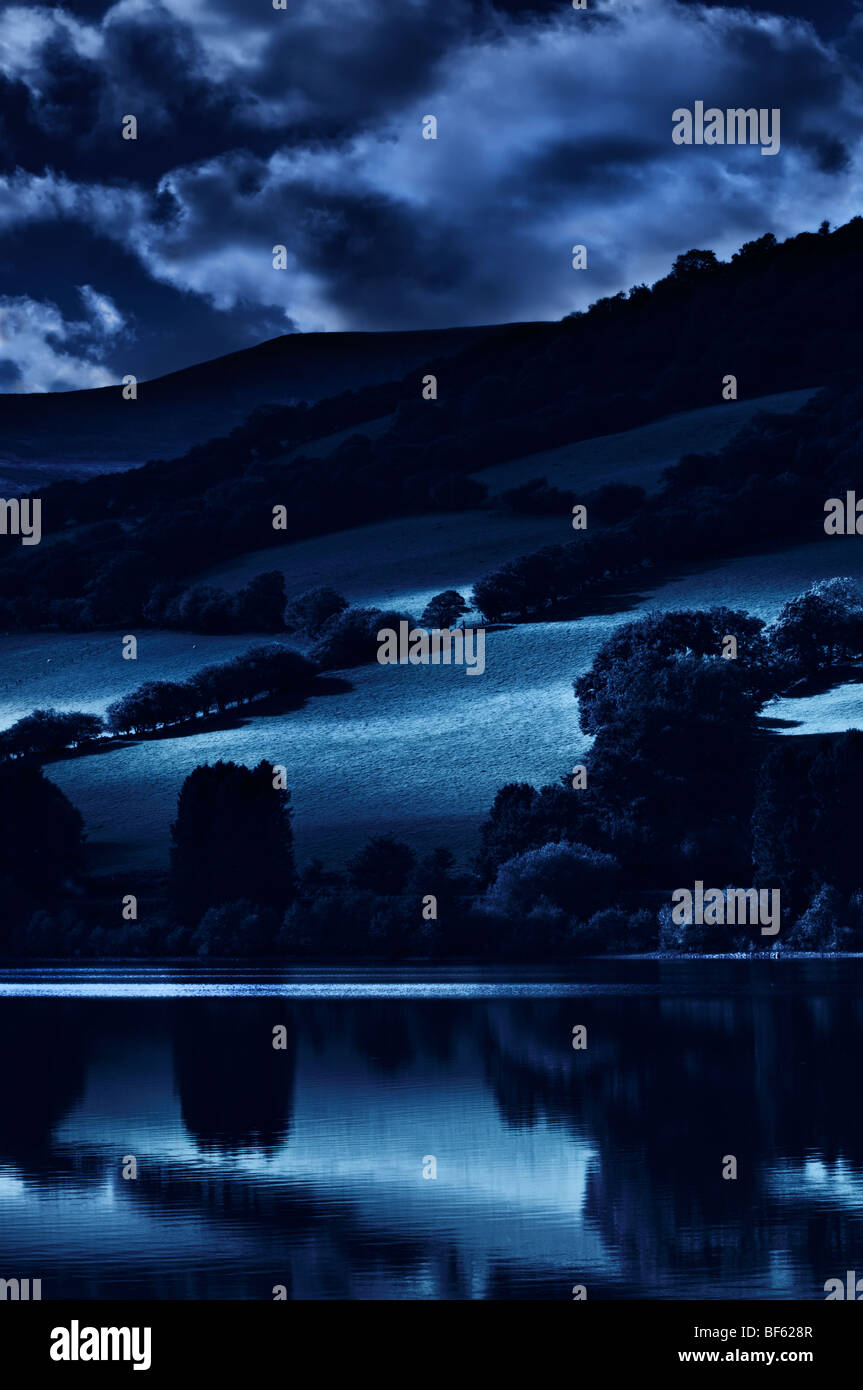 Perfect moonlit reflection at Talybont reservoir, Brecon Beacons in Wales Stock Photo