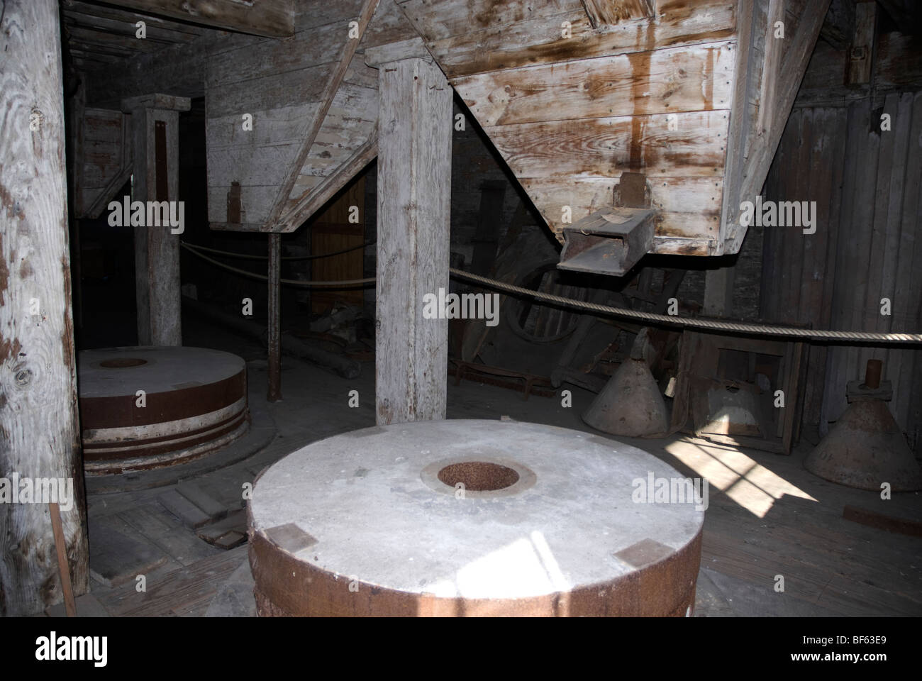 Grain grinding machinery inside the mill Three Mills Lea Valley North East London Stock Photo
