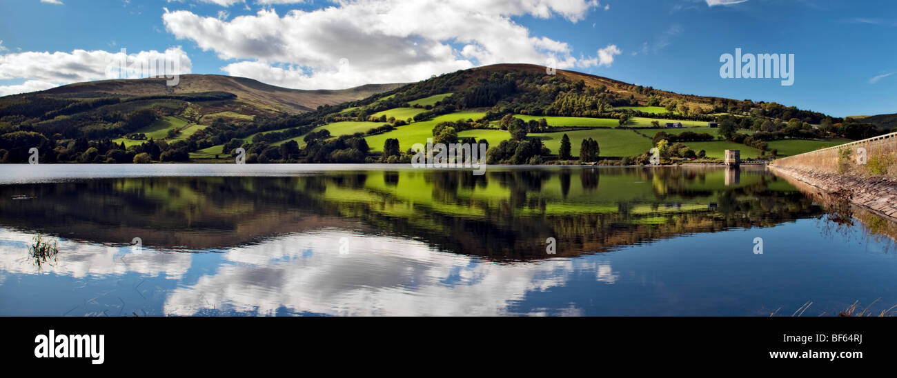 Panoramic perfect reflection at Talybont reservoir, Brecon Beacons in Wales taken on beautiful bright sunny day Stock Photo