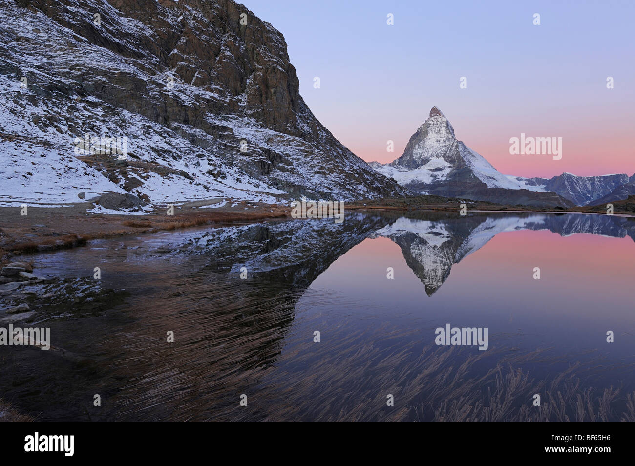 Matterhorn at sunrise in winter with reflection in the Riffelsee, Zermatt, Valais, Switzerland, Europe Stock Photo