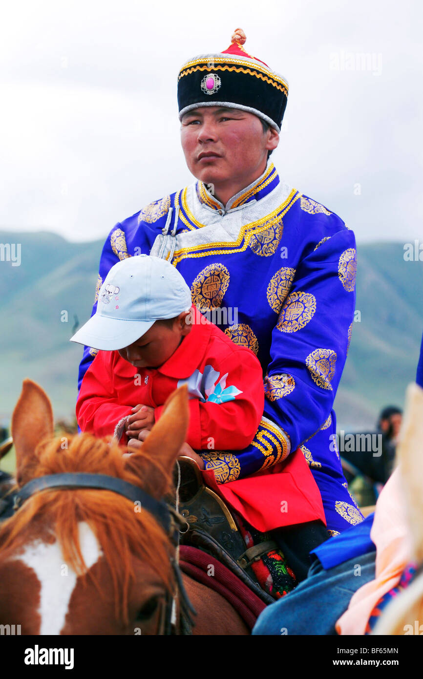 Mongolian man riding horse with his son, Nalati Grassland, Ili Kazakh ...