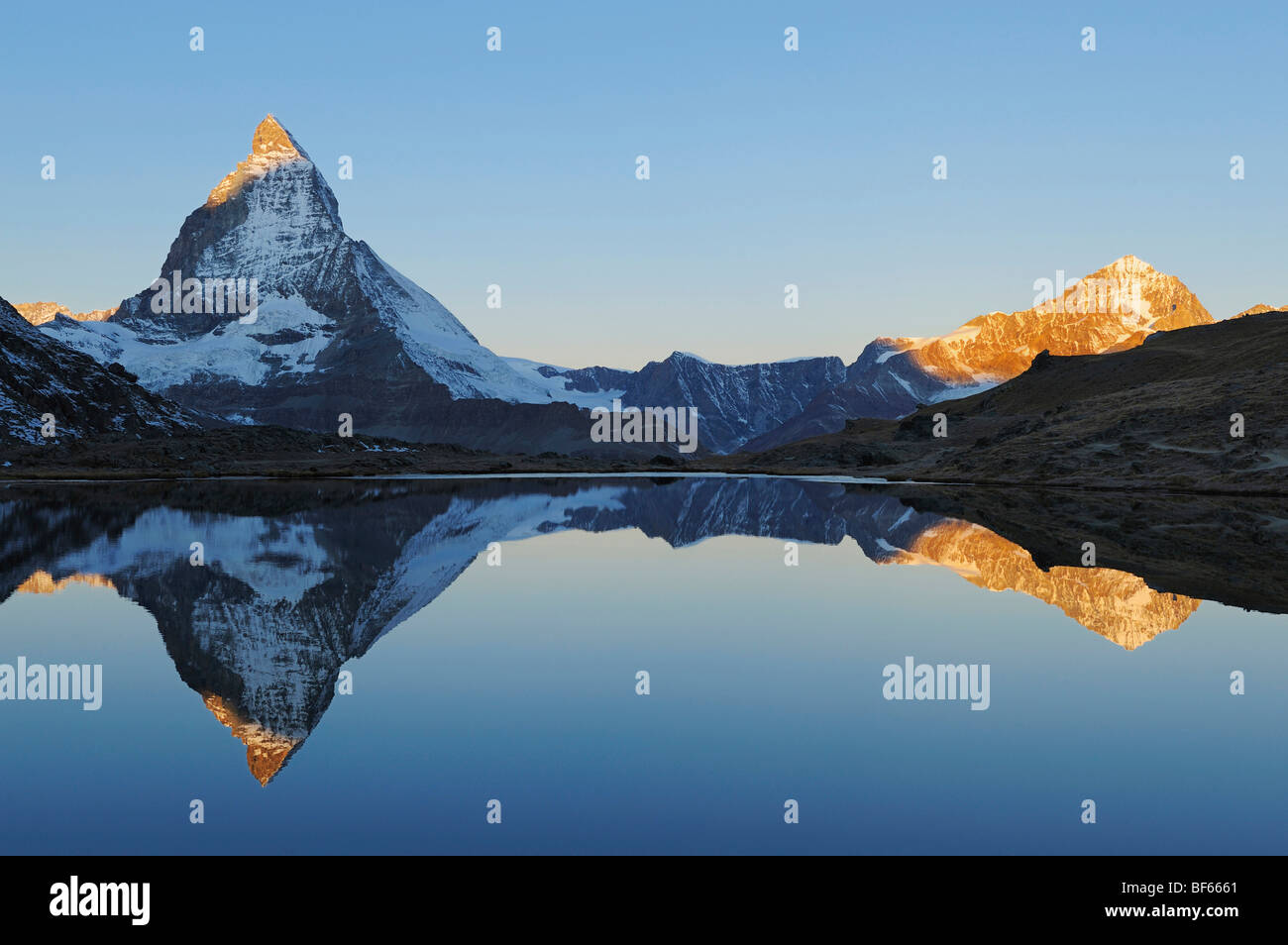 Matterhorn at sunrise in winter with reflection in the Riffelsee, Zermatt, Valais, Switzerland, Europe Stock Photo