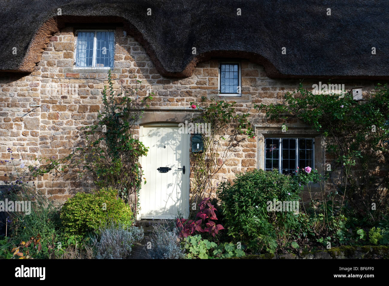 Rose Cottage, a thatched cottage made of local ironstone, in Great Tew