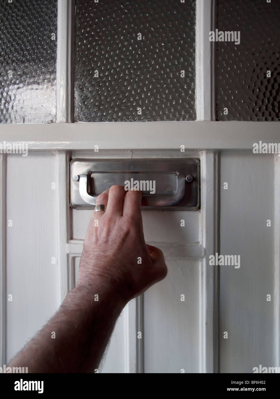 Hand knocking front door Stock Photo Alamy