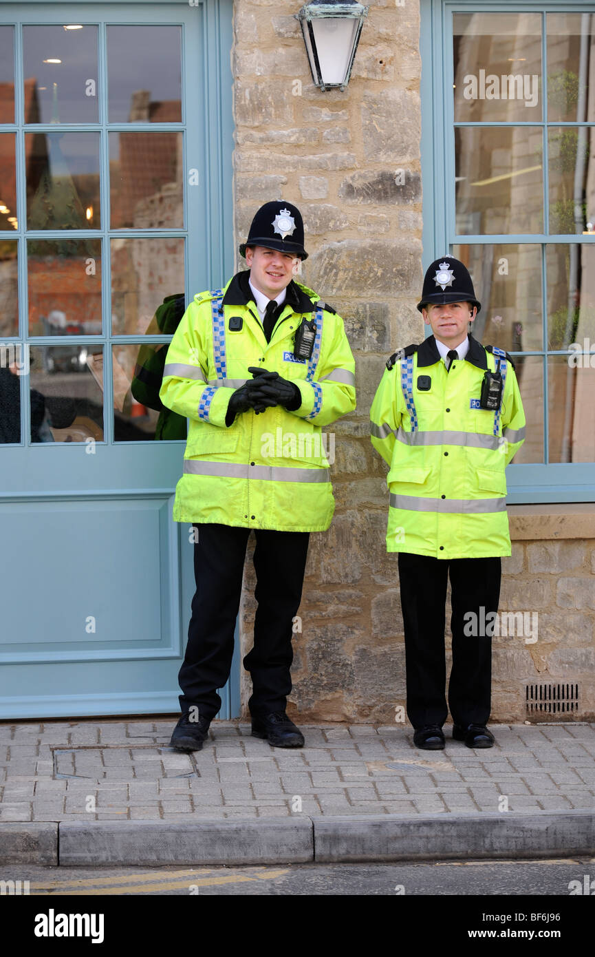 TWO POLICEMAN GUARDING A SHOP IN TETBURY GLOUCESTERSHIRE BEFORE A ROYAL VISIT UK Stock Photo
