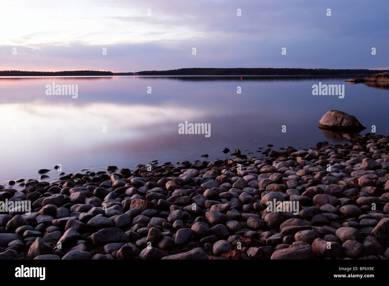 Late autumn evening on a rocky shore by lake Paijanne, Finland Stock Photo