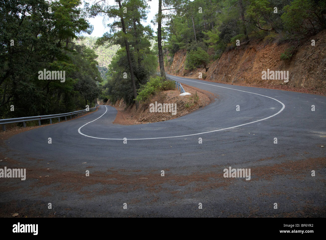 twisty hairpin bend in a mountain road in the troodos mountains forest republic of cyprus Stock Photo