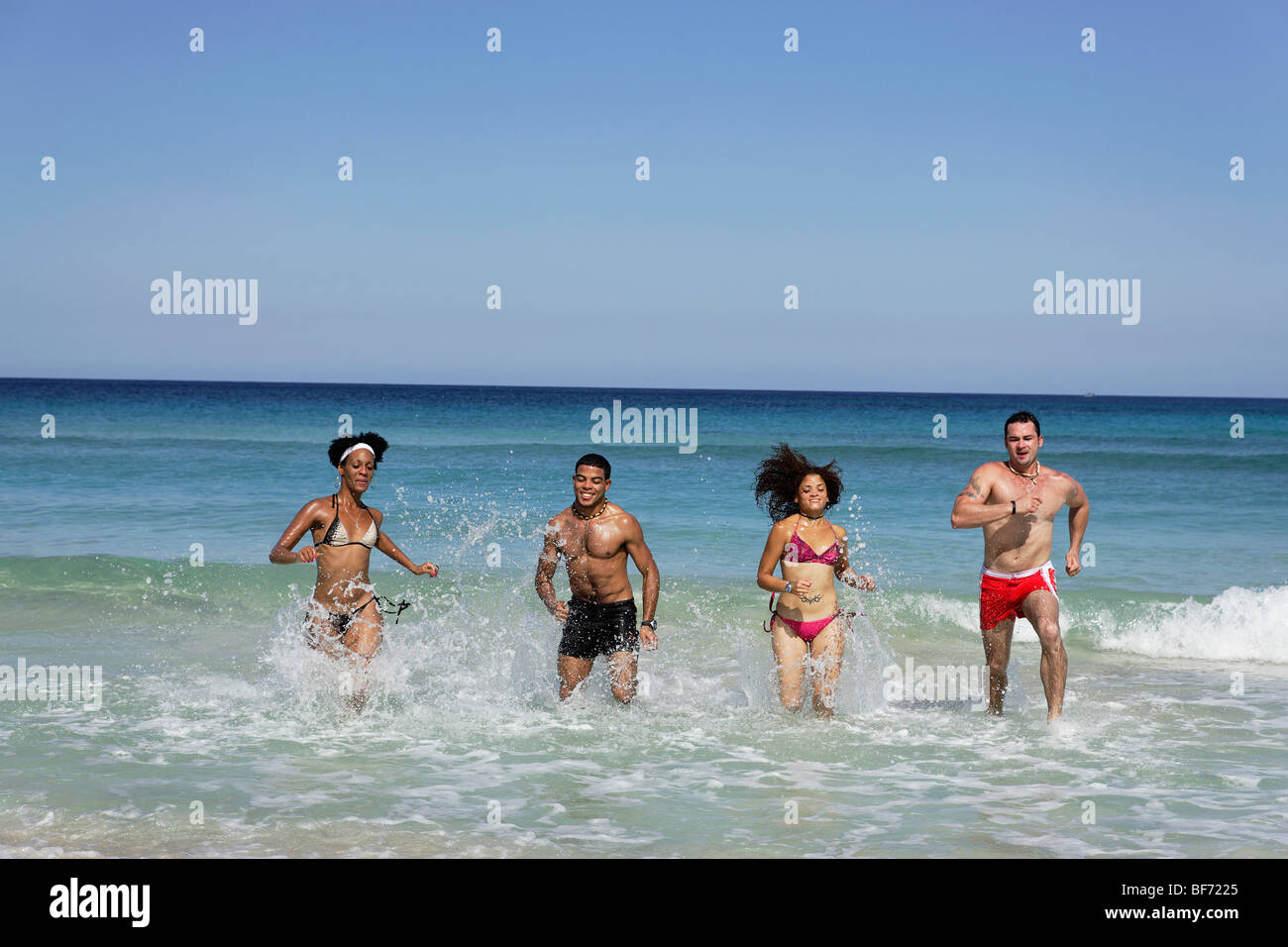 Group of young people running through water, Playas del Este, Havana, Ciudad de La Habana, Cuba, West Indies Stock Photo