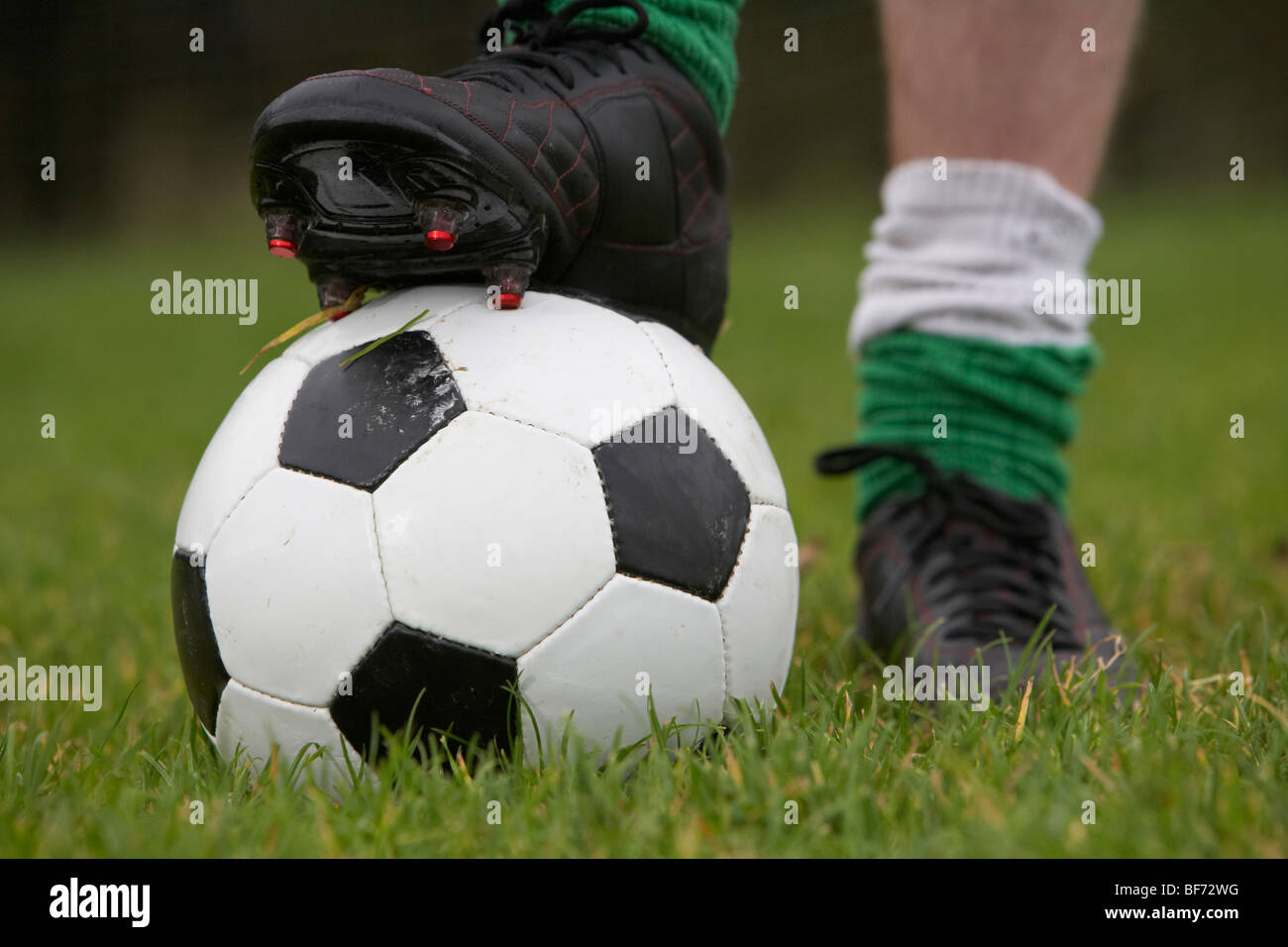 soccer football player with foot on the ball ready to take a kick Stock Photo