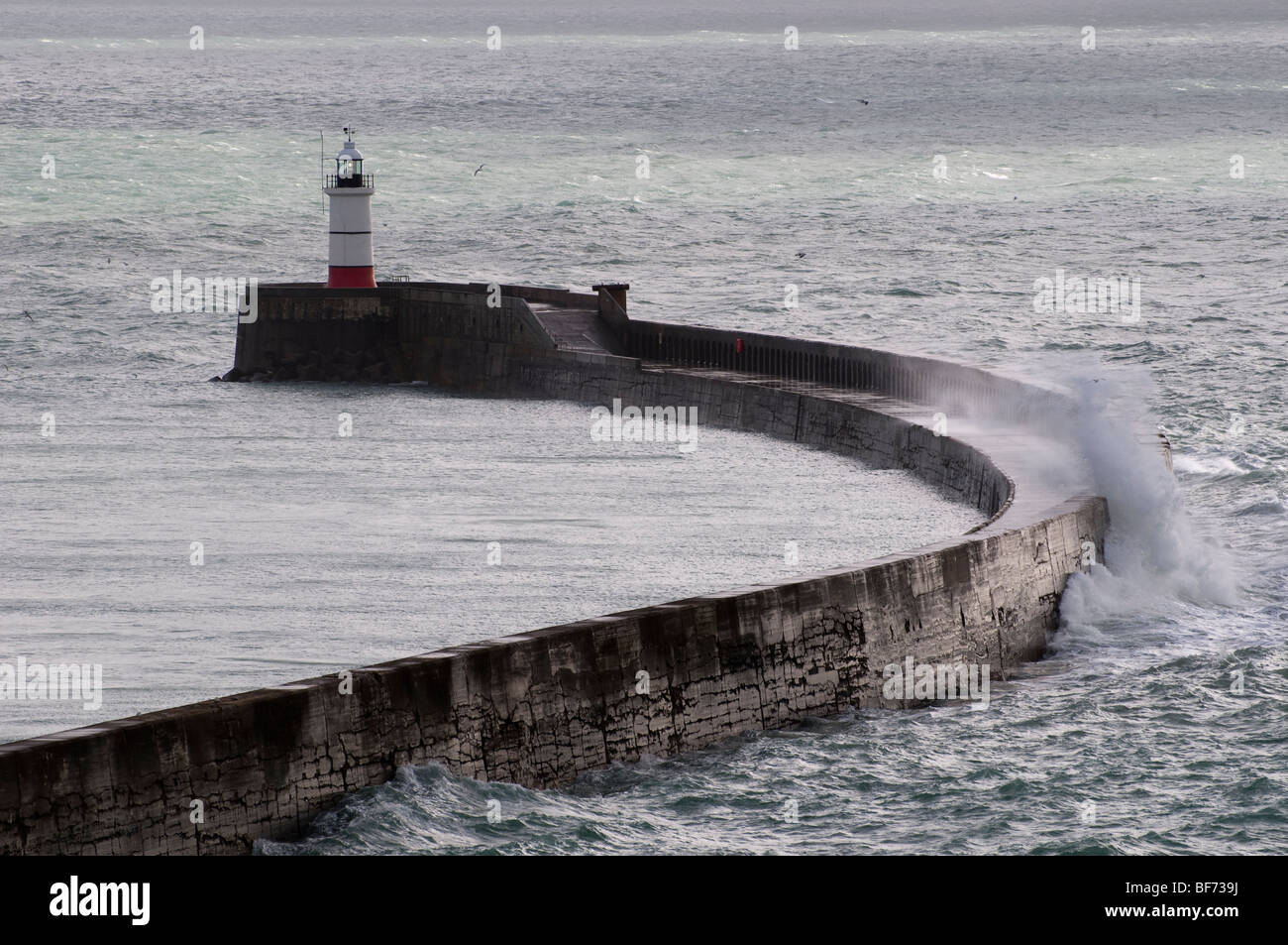 Sea waves hitting a sea wall at Newhaven, Sussex, England. Stock Photo
