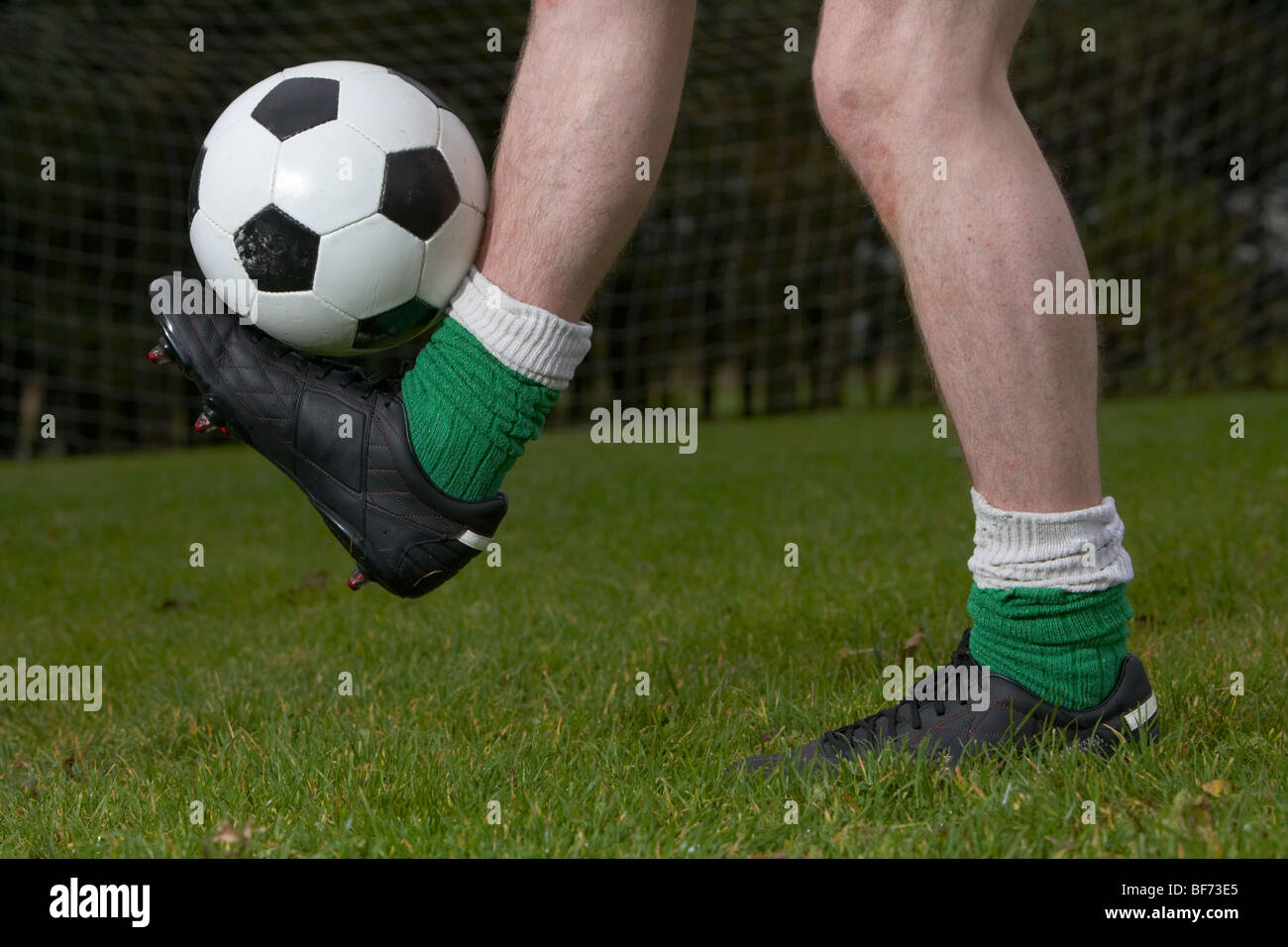 soccer football player balancing ball on one foot Stock Photo Alamy