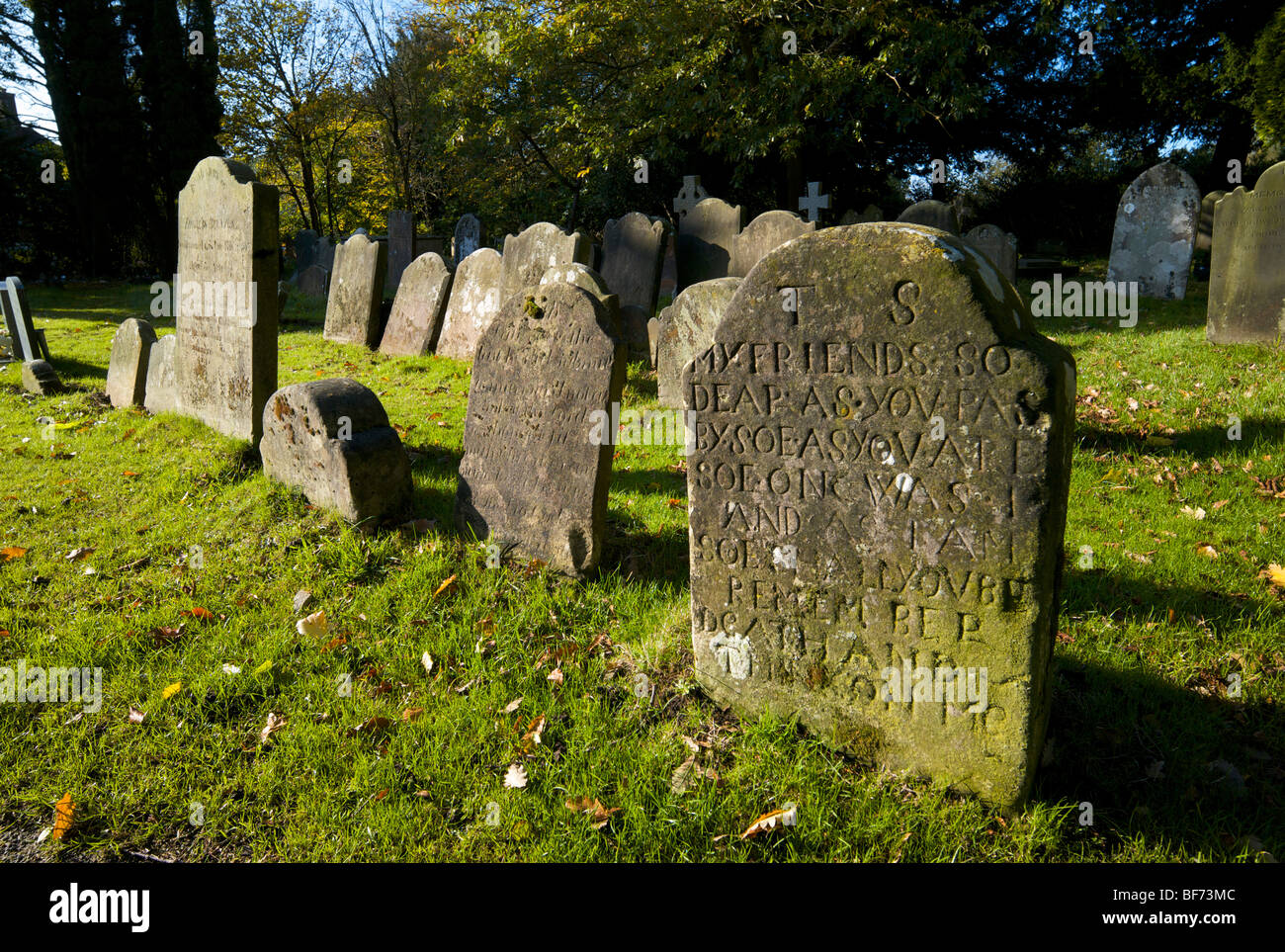 Old gravestones in the graveyard of St Nicholas church in Worth