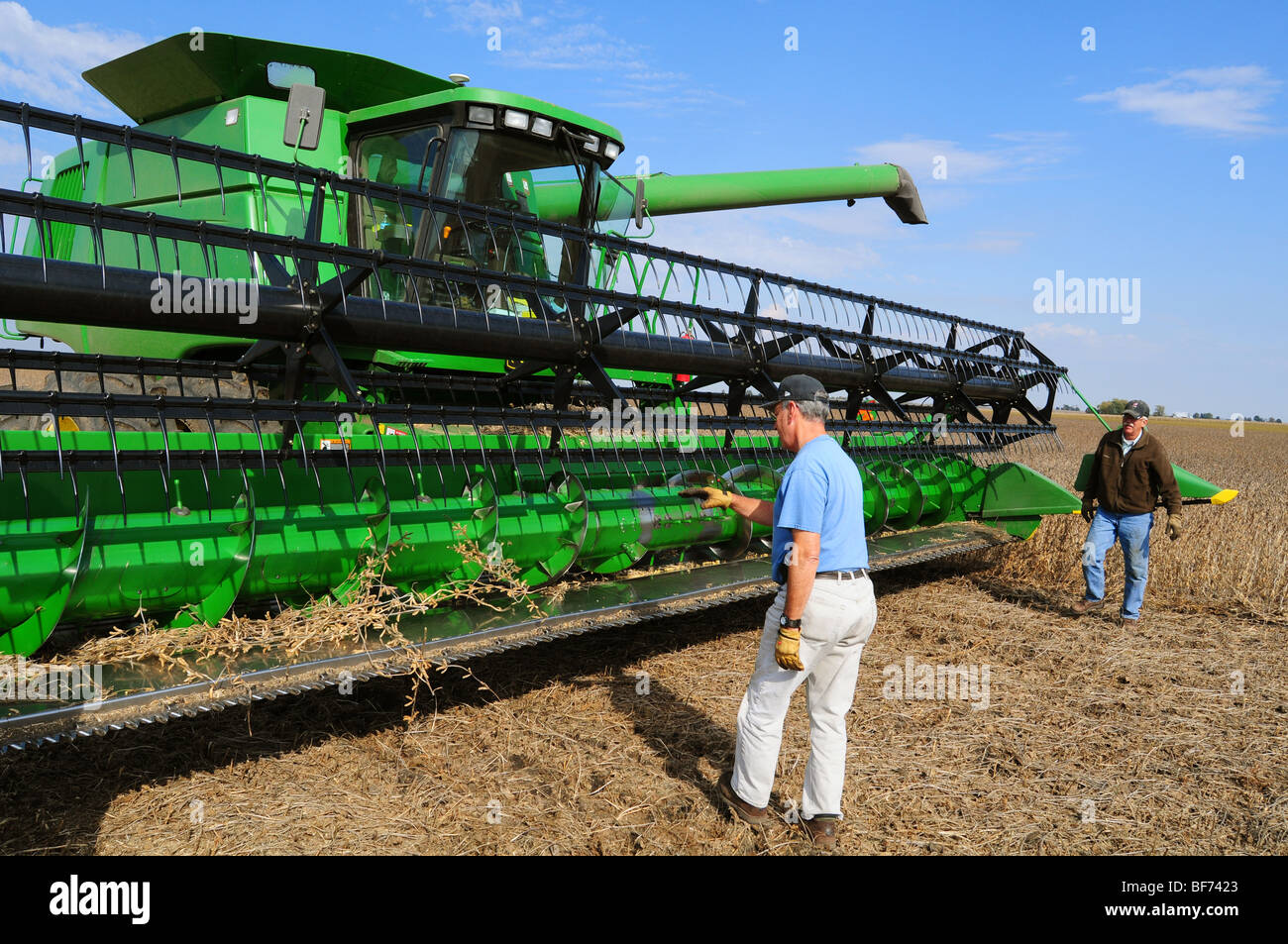 Cleaning and maintaining the John Deere combine during soybean harvest Stock Photo Alamy