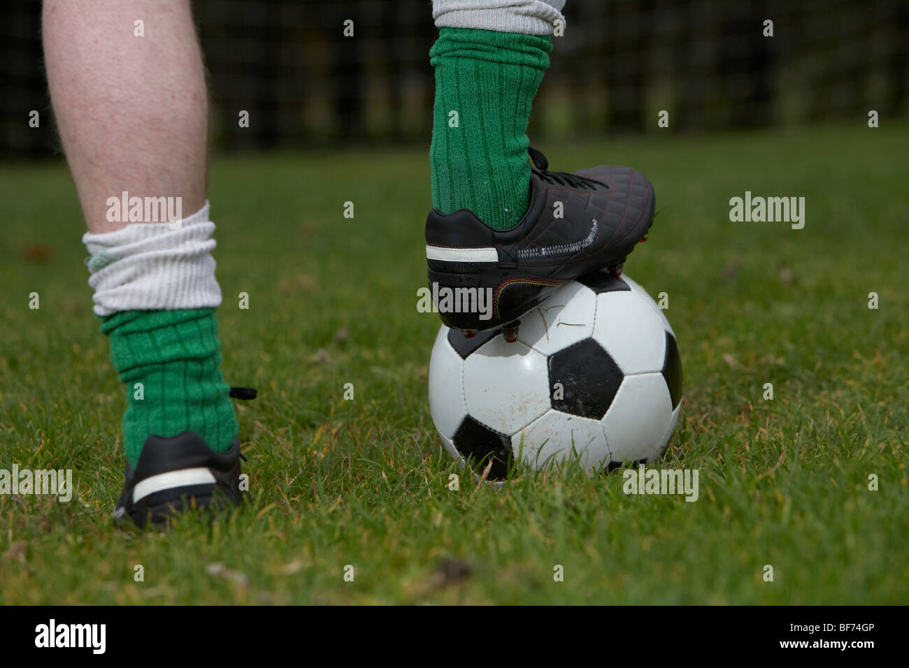 soccer football player with foot on the ball ready to take a kick Stock Photo