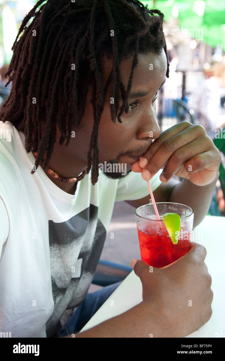 African man drinking a Cranberry juice Stock Photo Alamy