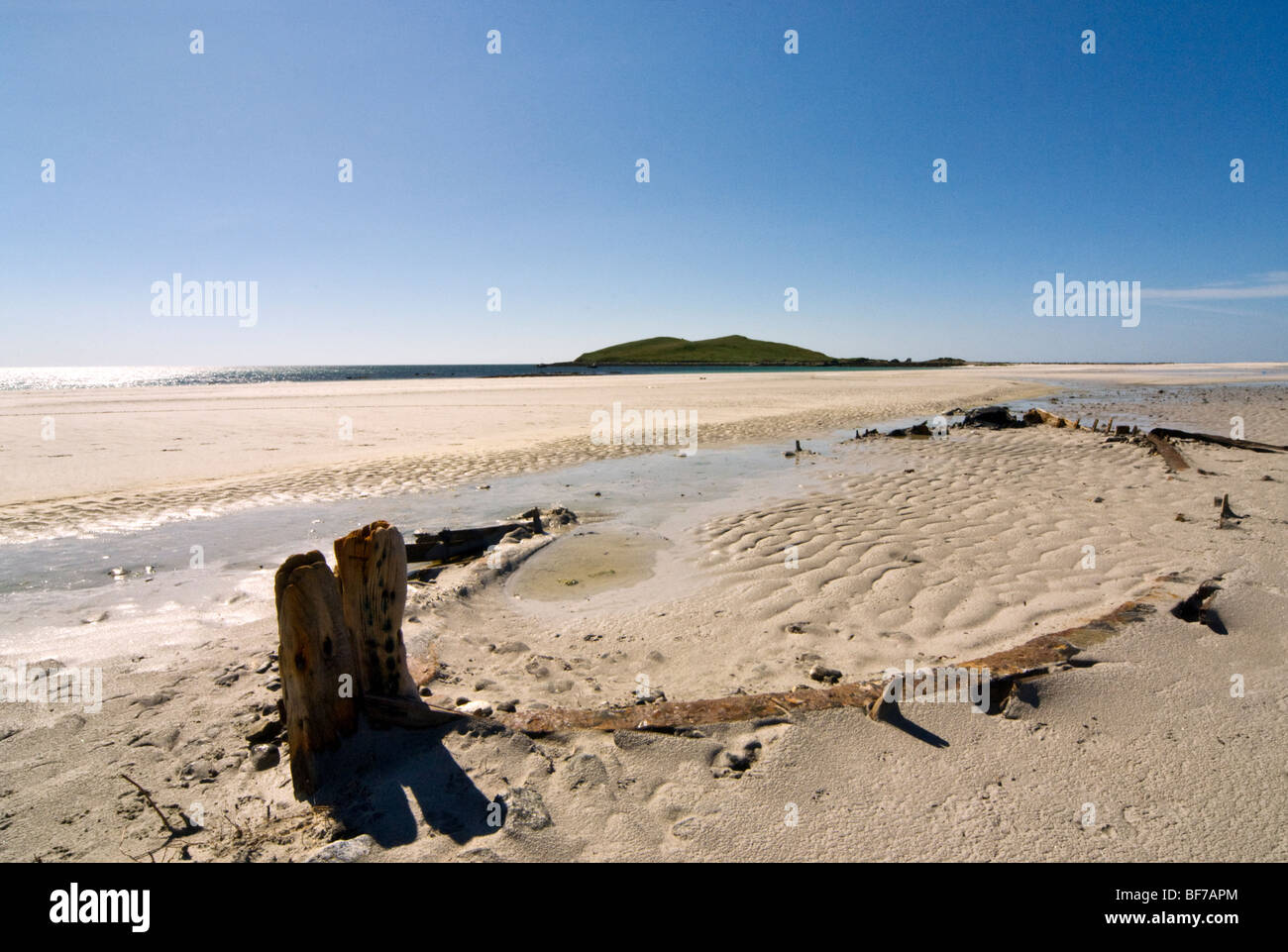 Looking towards Eilean Orosay, Innse Gall with boat skeleton on beach, South Uist, Scotland, UK Stock Photo