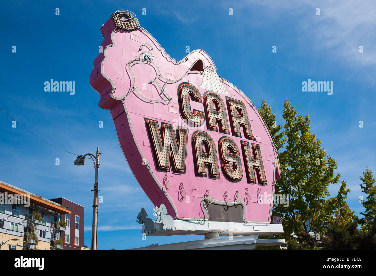The pink elephant car wash rotating sign stands out as a humorous tasteless detail in the Seattle city. Stock Photo