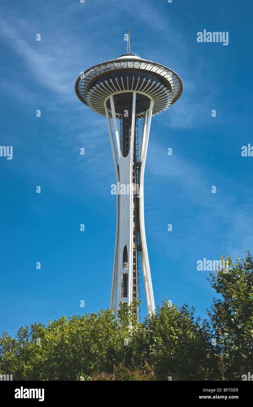 The famous Space Needle landmark building against a blue sky and green trees in the summer in Seattle, Washington, USA. Stock Photo