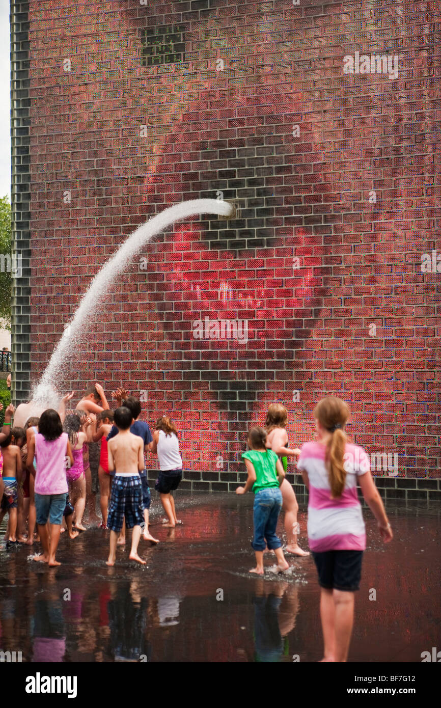 children play in the Crown Fountain, Millenium Park, Chicago, Illinois, United States of America Stock Photo