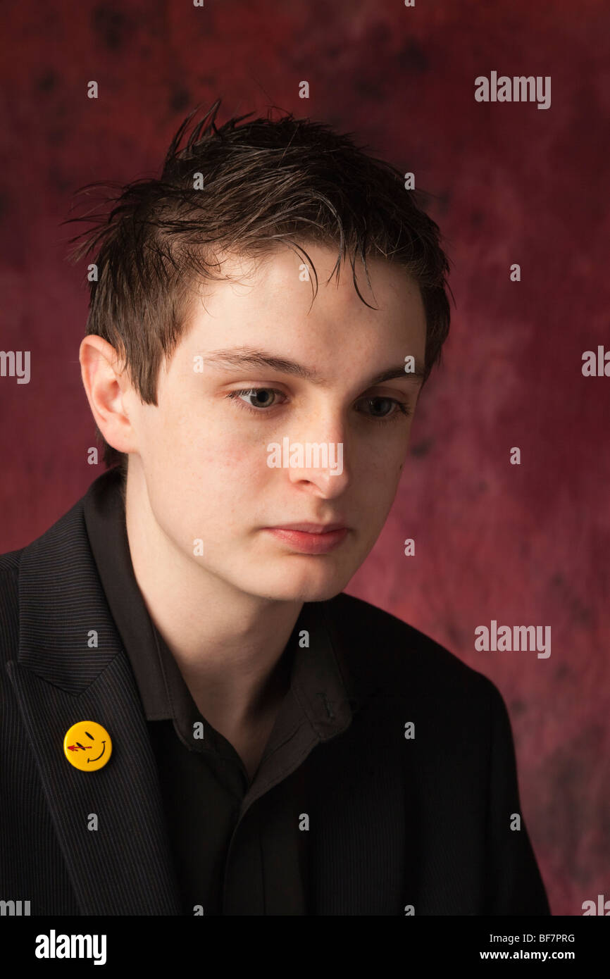 Studio, UK, Britain. Head and shoulders portrait of a teenage boy with