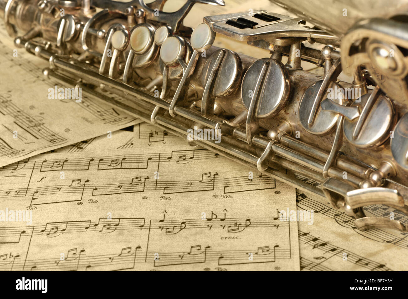 First Saxophone Notes Old saxophone and notes. The Musical instrument laying on notes with ...