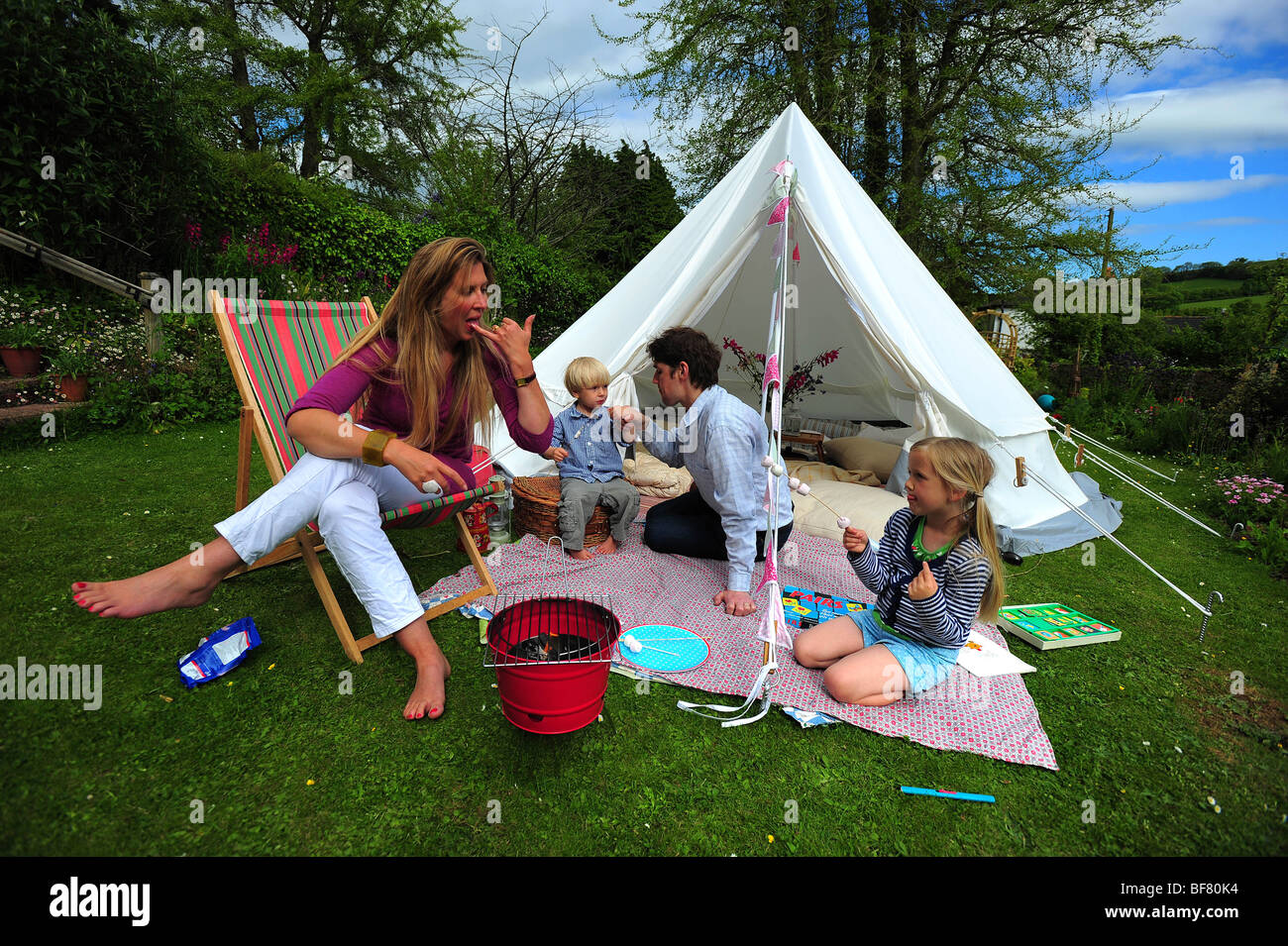 A Family Camping With A Fabric Tent In Their Garden In Devon Uk Stock Photo Alamy