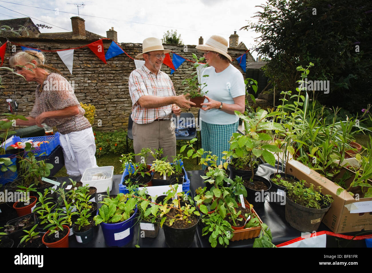 People selling plants at rural village Fete in the Cotswolds, Eastleach Turville