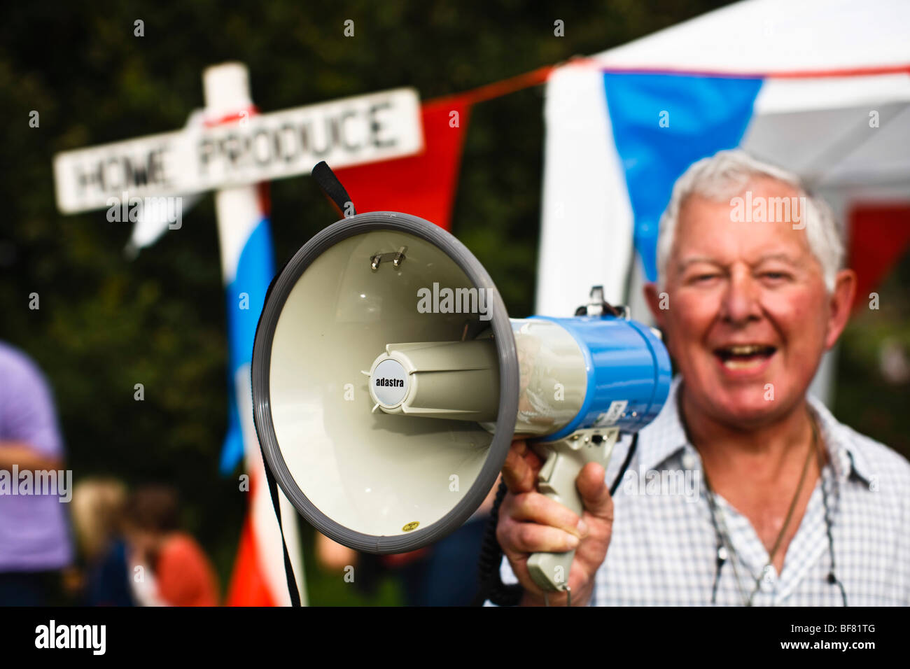 Man making announcement on a megaphone at a rural village Fete in the