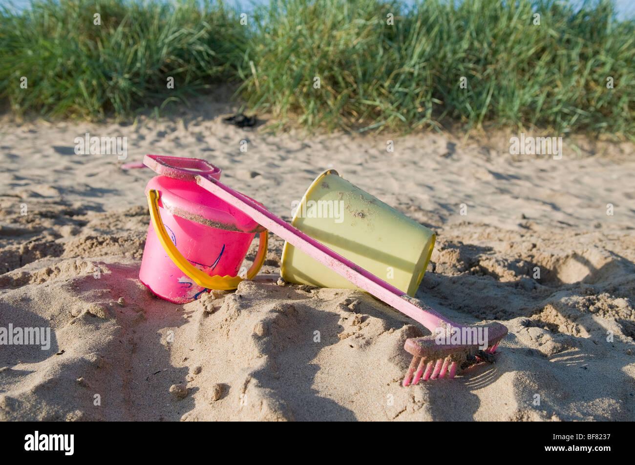 Colourful bucket and spade on a sandy beach Stock Photo Alamy