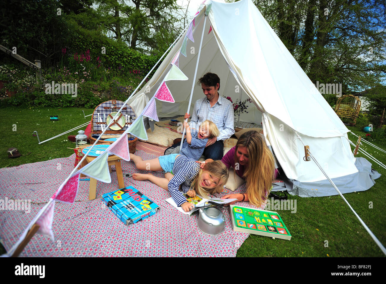 A Family Camping With A Fabric Tent In Their Garden In Devon Uk Stock Photo Alamy