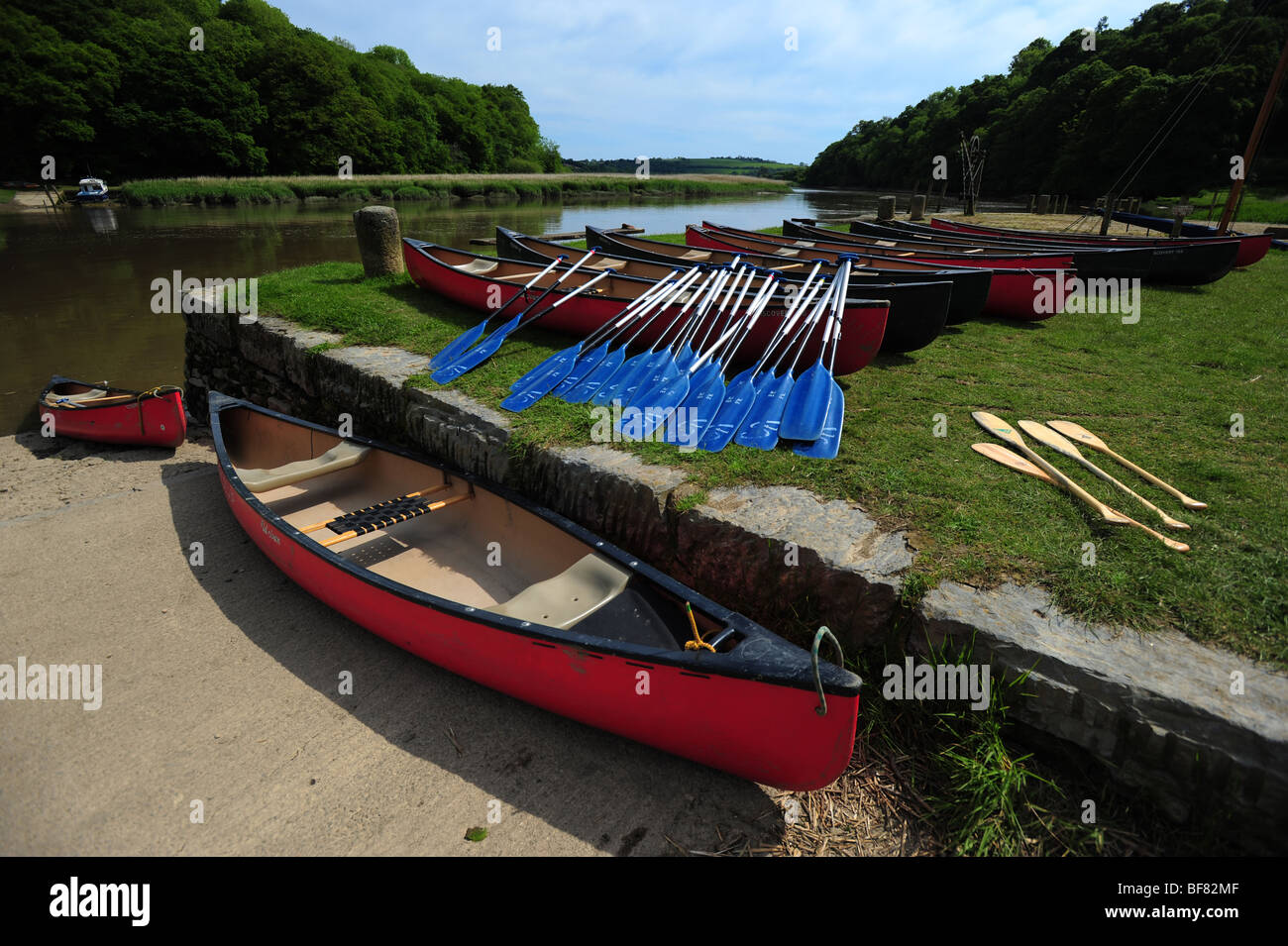 canoes and kayaks resting on the bank of the River Tamar, on the Devon