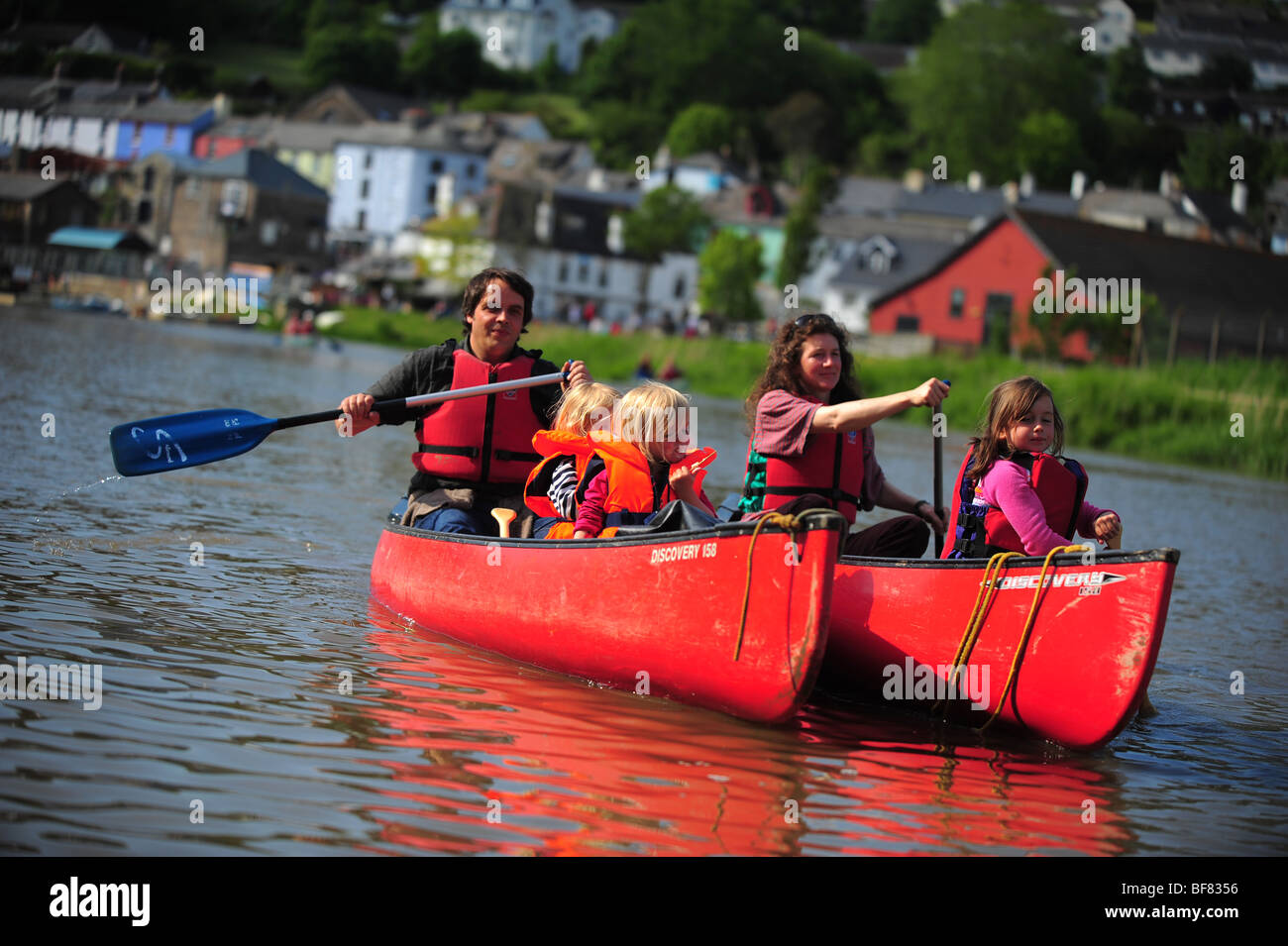 A family canoeing and kayaking on the River Tamar, on the Devon and Cornwall border, UK Stock Photo