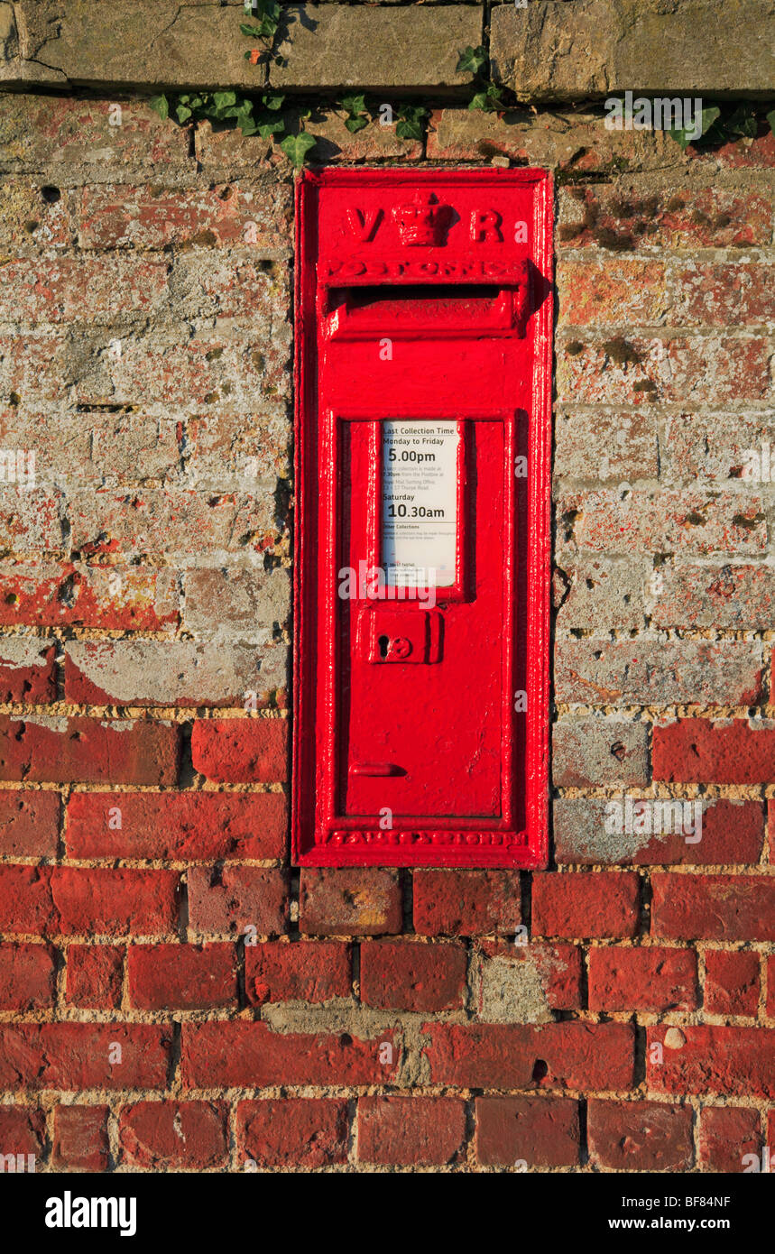 Early Victorian postbox located in a purpose built wall at Tunstead, Norfolk, United Kingdom. Stock Photo