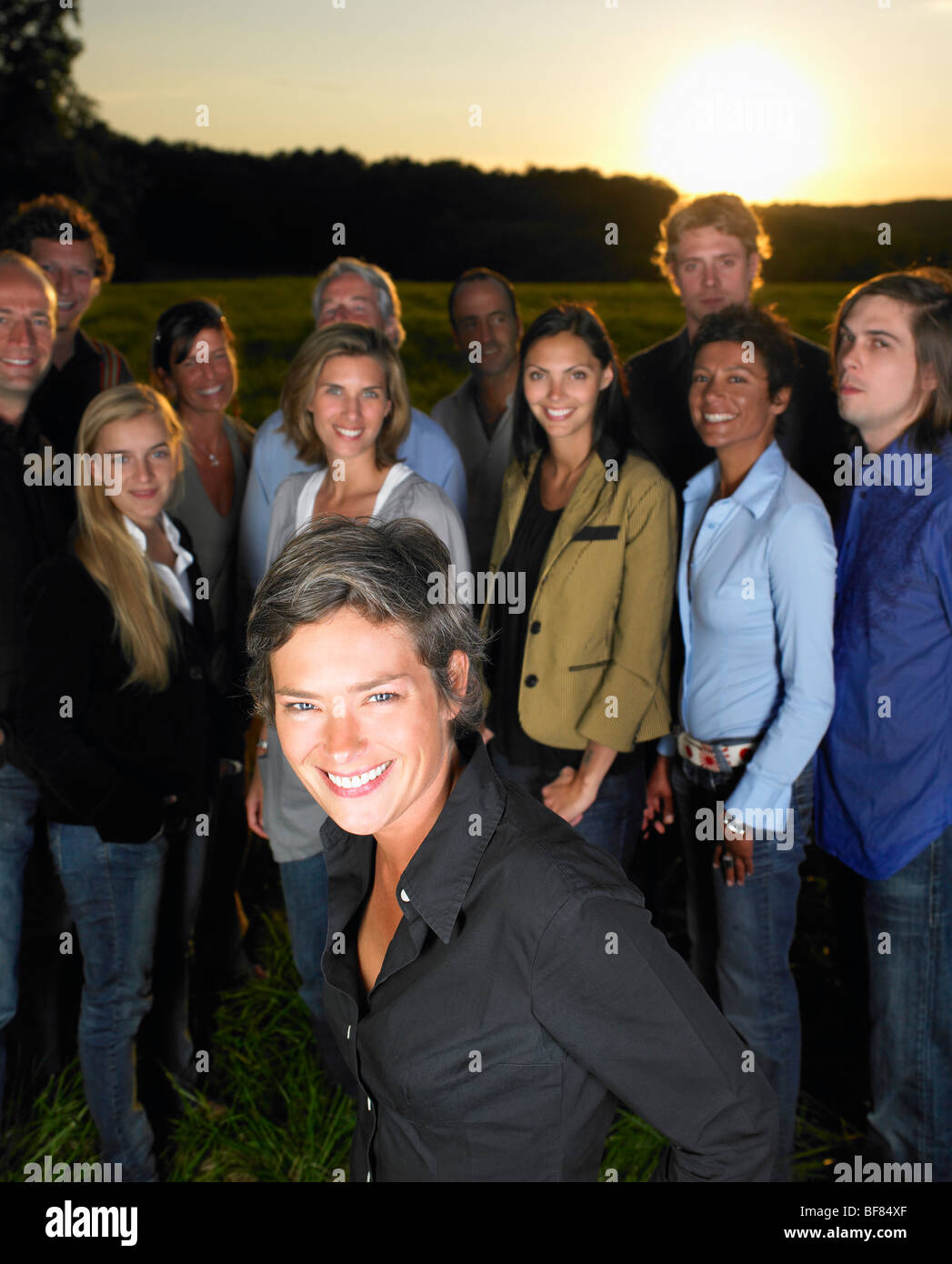 group of people standing in a field Stock Photo - Alamy