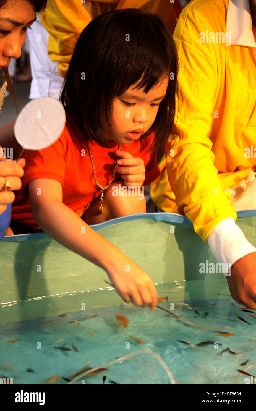 Children playing Fishing Game , Bangkok 's Chinatown , Thailand Stock Photo