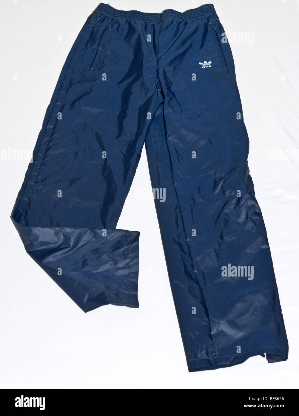 Adidas waterproof nylon tracskuit trousers bottoms. Adidas Trefoil logo. Sportswear branded menswear clothing. Stock Photo