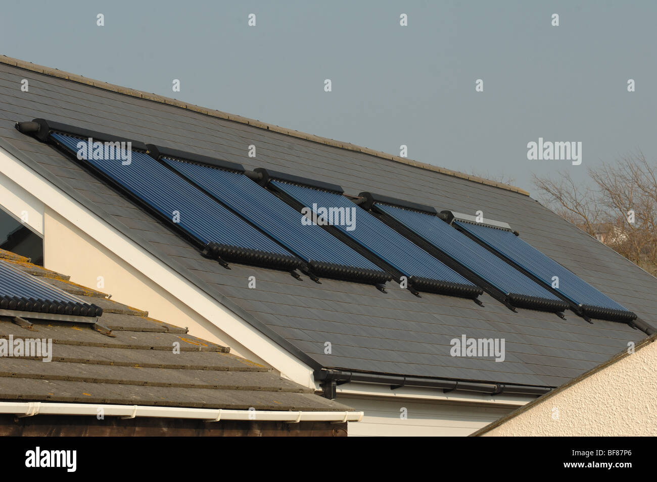 Large array of evacuated solar water heating tubes on roof of an outdoor activity centre in north devon england uk  Stock Photo