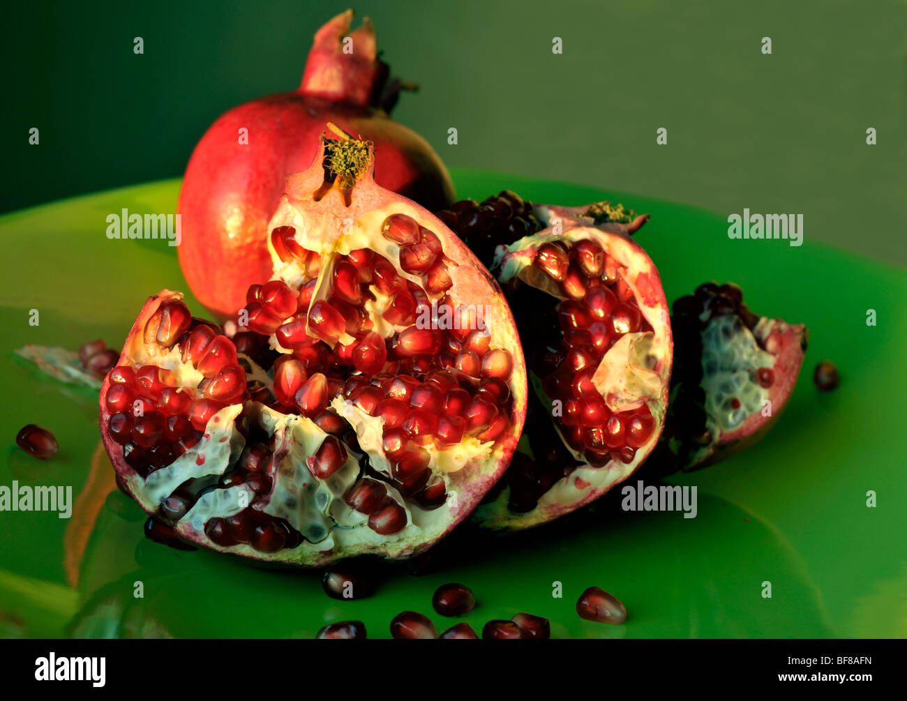 pomegranate on green dish Stock Photo