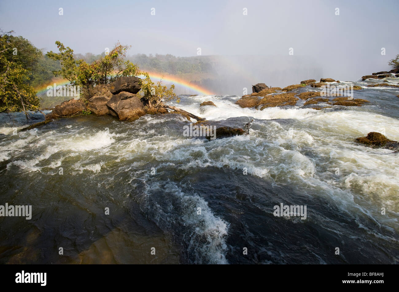 Victoria Falls on the Zambian side with rainbow. Stock Photo