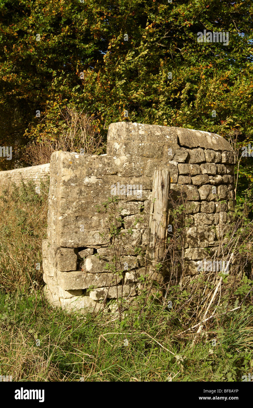 Dry stone wall and old gatepost, Cotswolds, England. Stock Photo