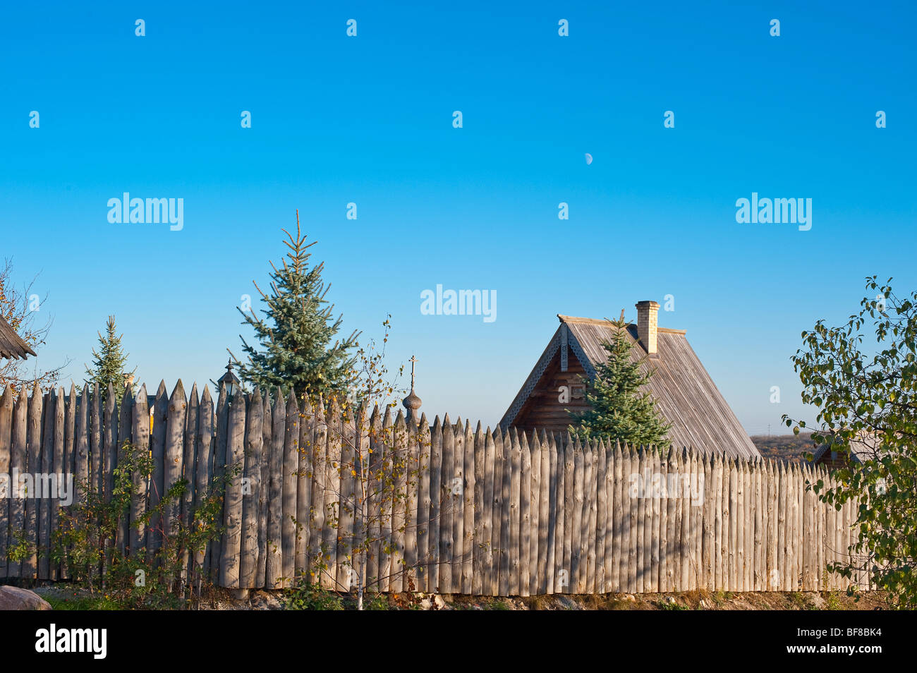 The house in village. The wooden house with a fence Stock Photo - Alamy