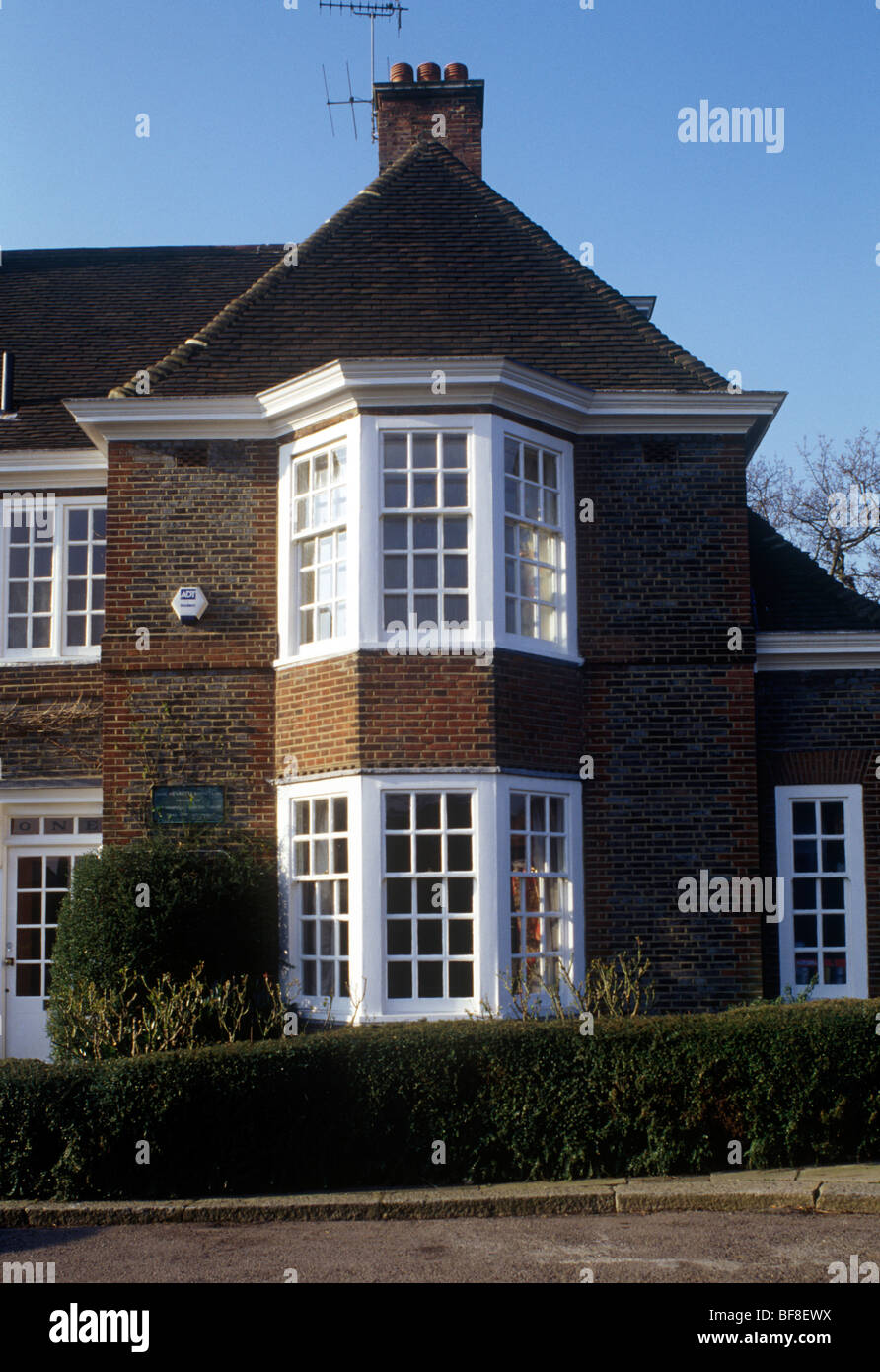 Hampstead Garden Suburb, north London UK desirable semi-detached house with oriel windows showing sun inside Stock Photo