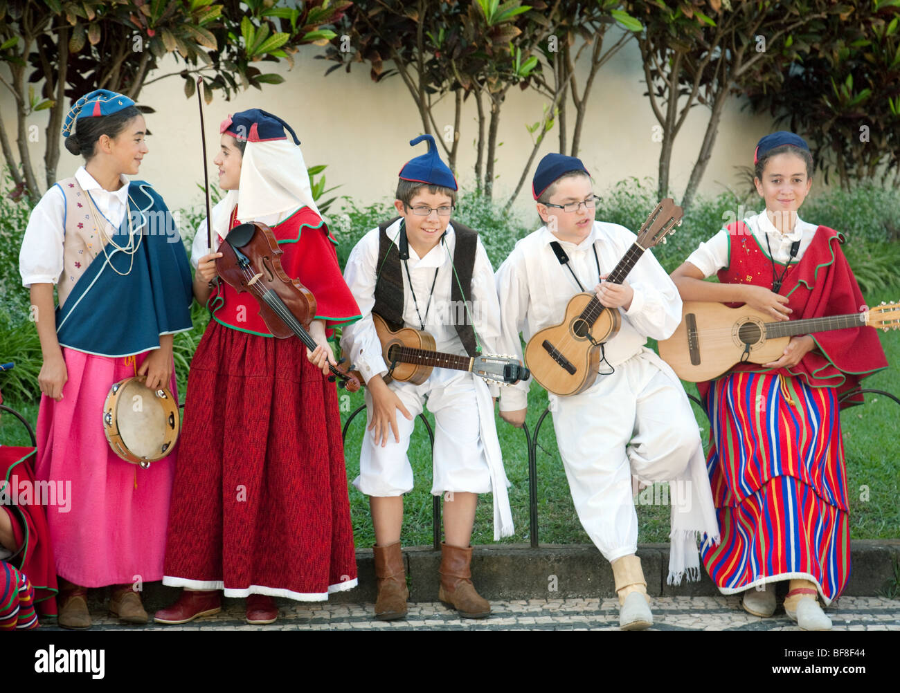Madeiran children in traditional costume playing musical instruments and dancing, Funchal, madeira Stock Photo
