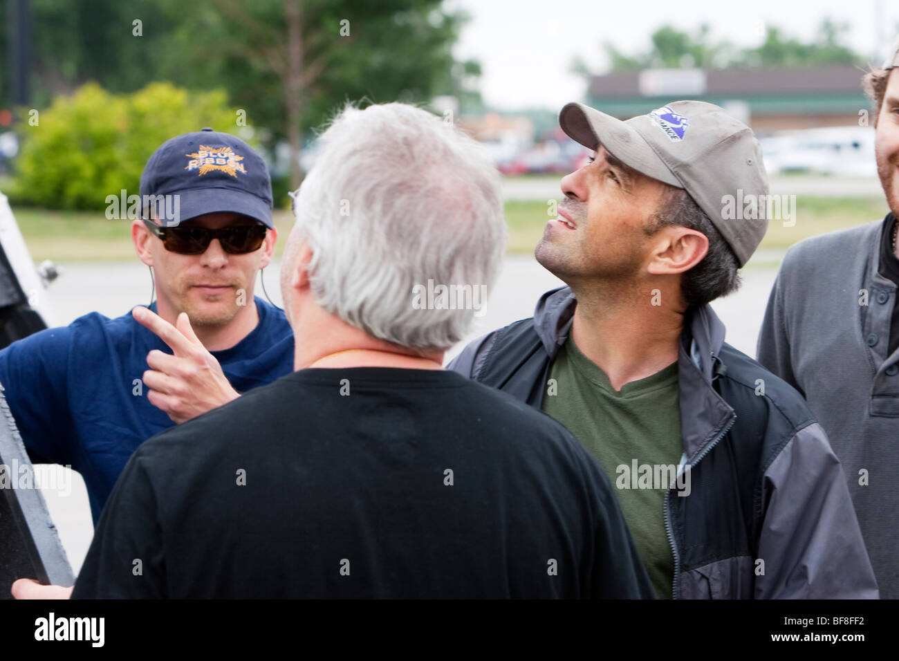 Josh Wurman of the Center for Severe Weather Research speaks to storm chasers Sean Casey and Ronan Nagle in Kearney, Nebraska. Stock Photo