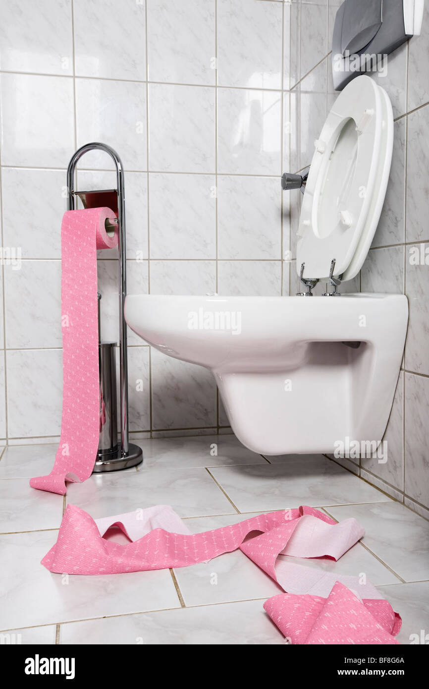 White toilet with pink toilet paper Stock Photo