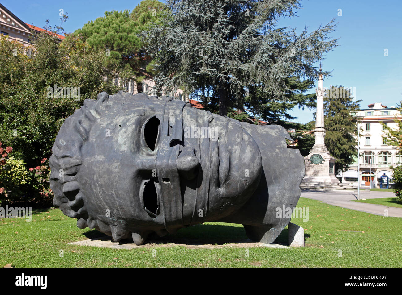 Over size sculpted head of Eros, public square, Lugano, Ticino Stock Photo