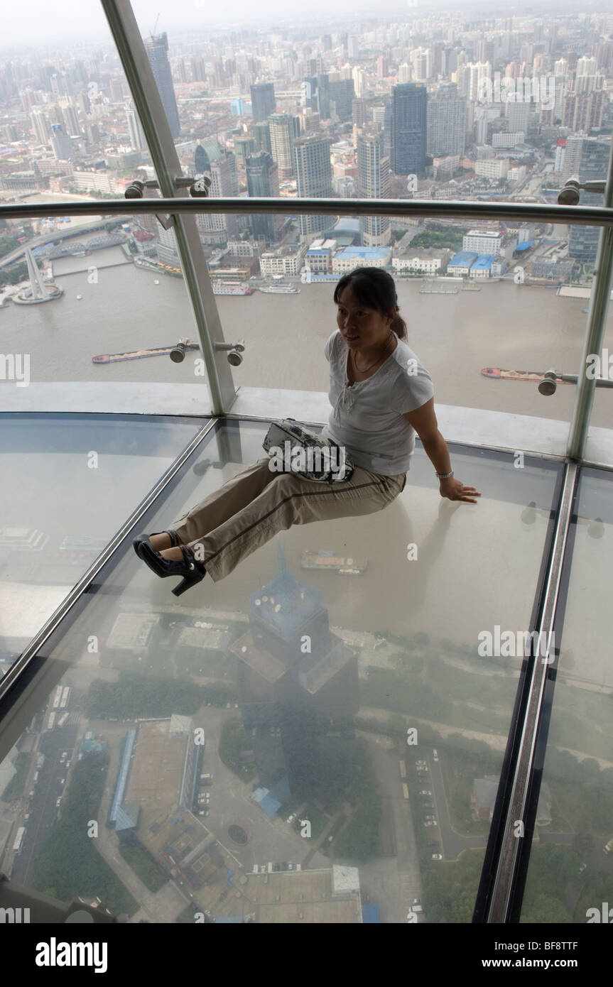 Female tourist sitting on the glass floor on top of the Oriental Pearl  Tower. Pudong, Shanghai, China Stock Photo - Alamy