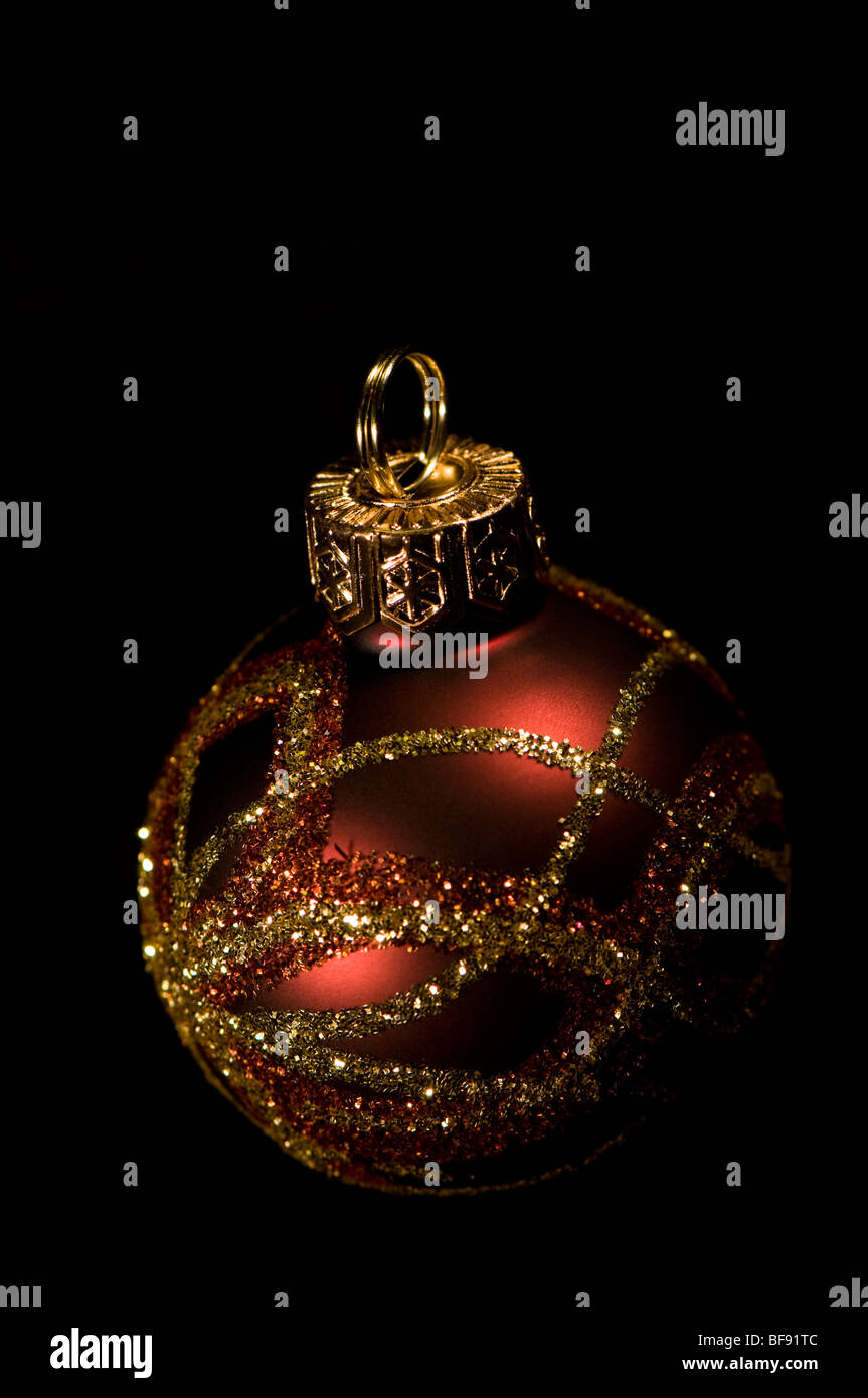 Glittery Christmas bauble against a black background Stock Photo - Alamy